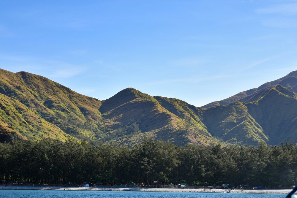 Beach with mountain range backdrop