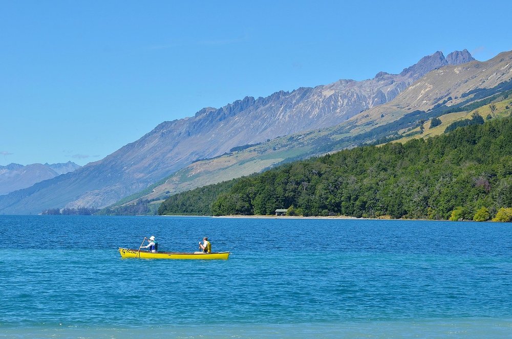 a yellow boat in a lake