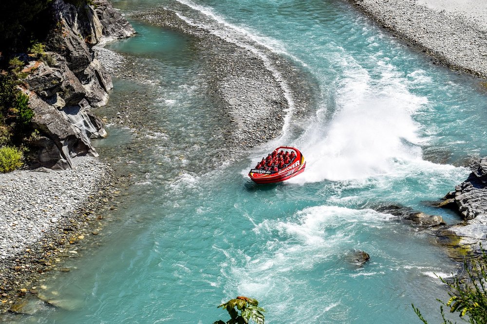 Red boat cruising the river
