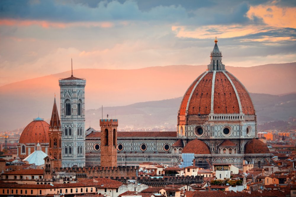 best airport to fly into italy - Florence Cathedral with city skyline viewed from Piazzale Michelangelo at sunset 