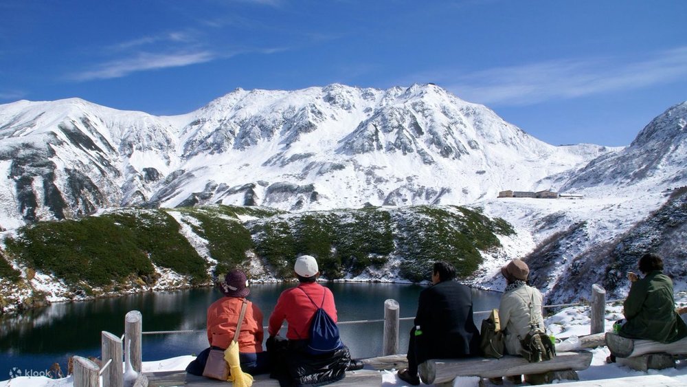 what to do in nagoya - people in front of a mountain, tateyama kurobe