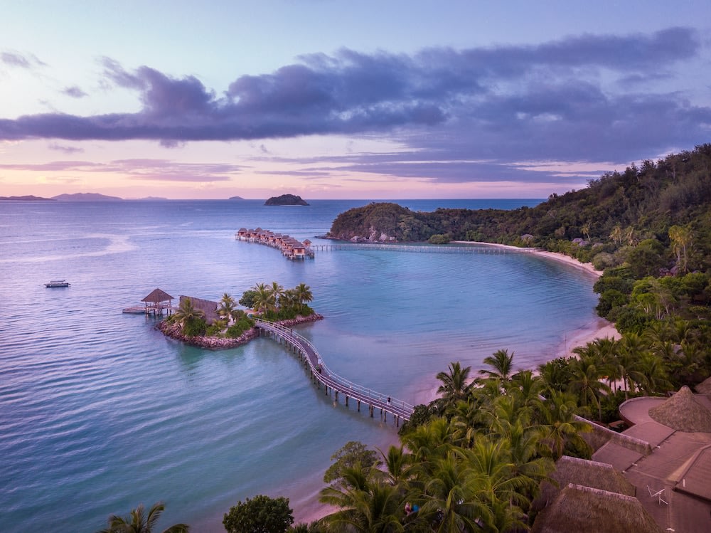 fiji bungalows over the water - ocean surrounded by island