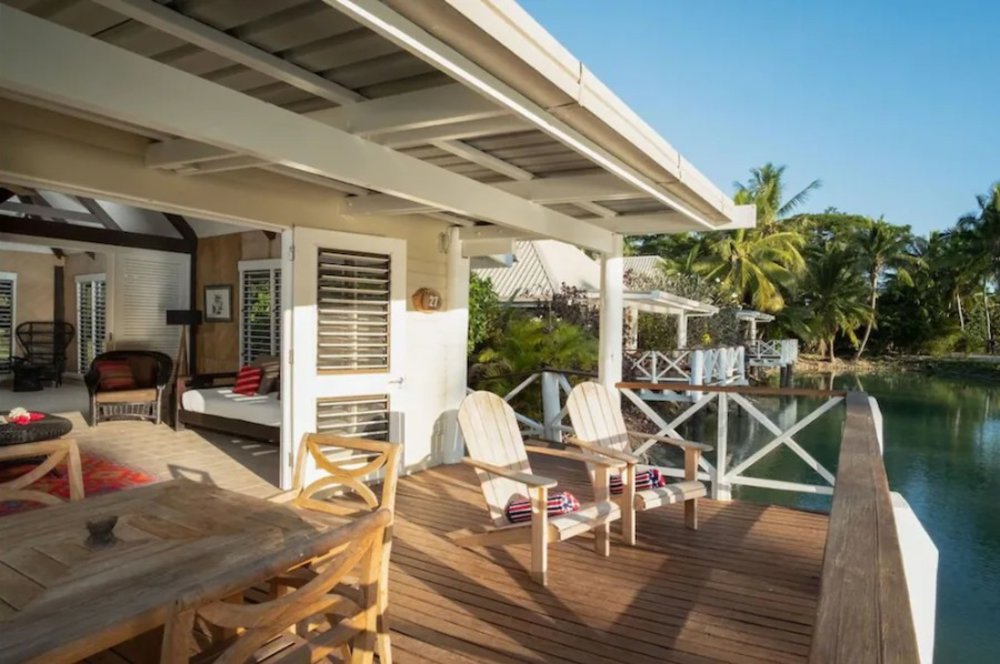 fiji bungalows over the water - patio with sunlight and water