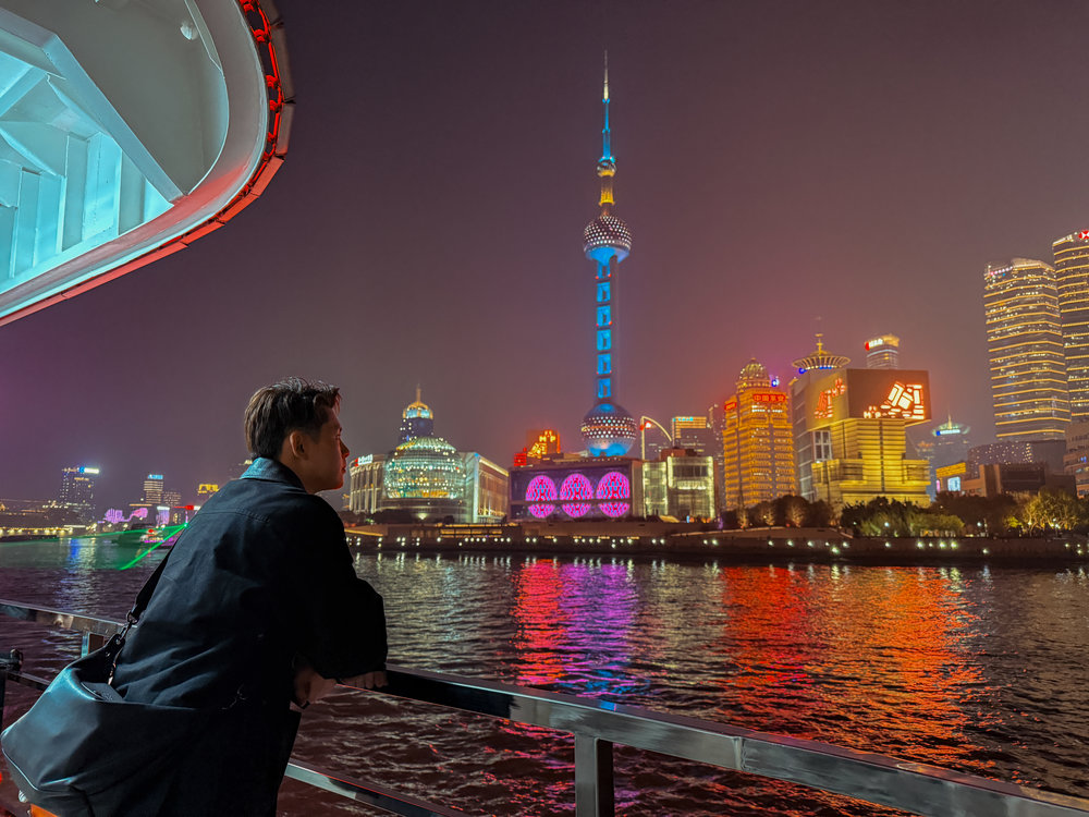 Shanghai Itinerary for First Timers - Traveler on Huangpu River Cruise at Night