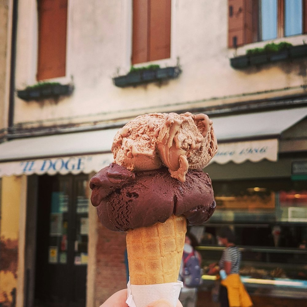 rome at night - hand holding gelato in front of shop