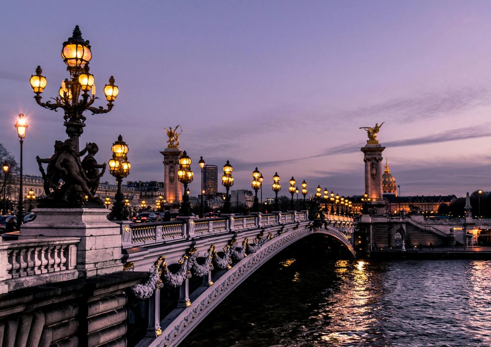 paris at night - bridge over water at sunset
