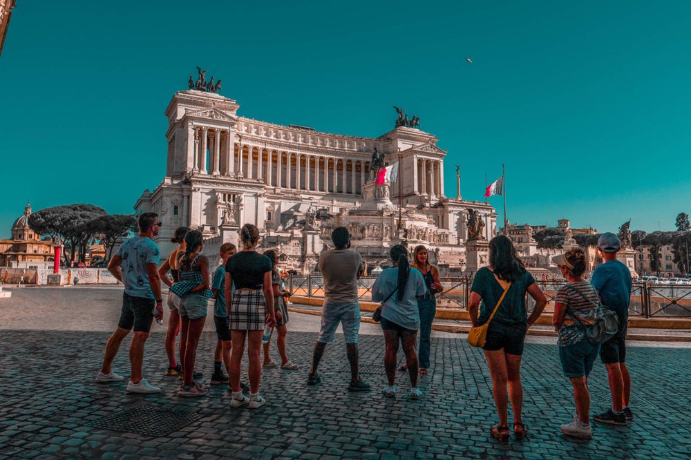 ancient roman buildings - group of people standing in front of ancient building