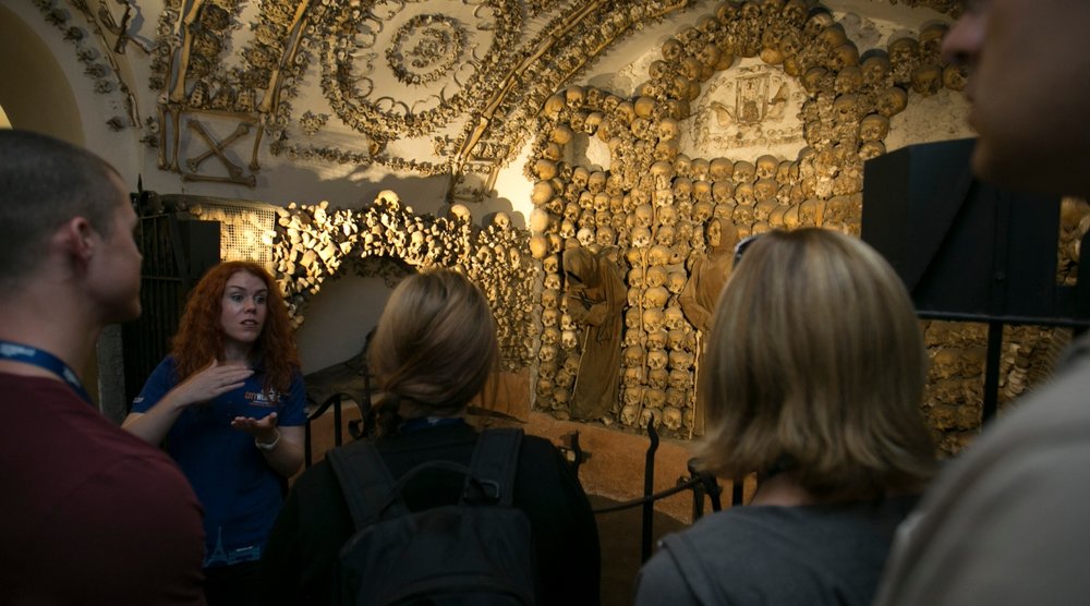 Tourists listening to a tour guide in Rome