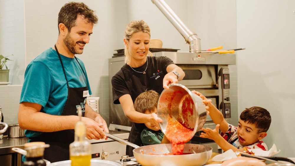 A family at a pasta-making class