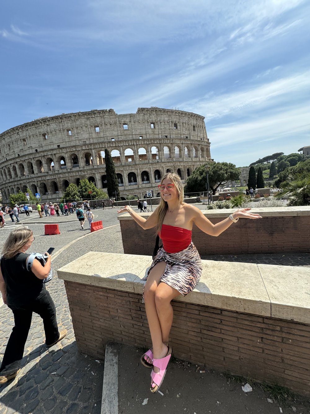 woman posing with rome colosseum in the background