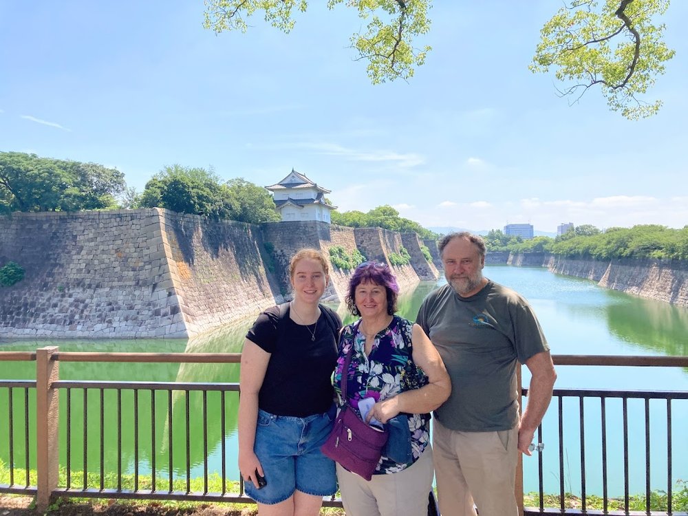 a group of people posing in osaka