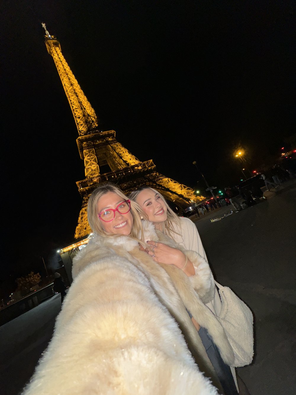 Selfie in front of Eiffel Tower at night