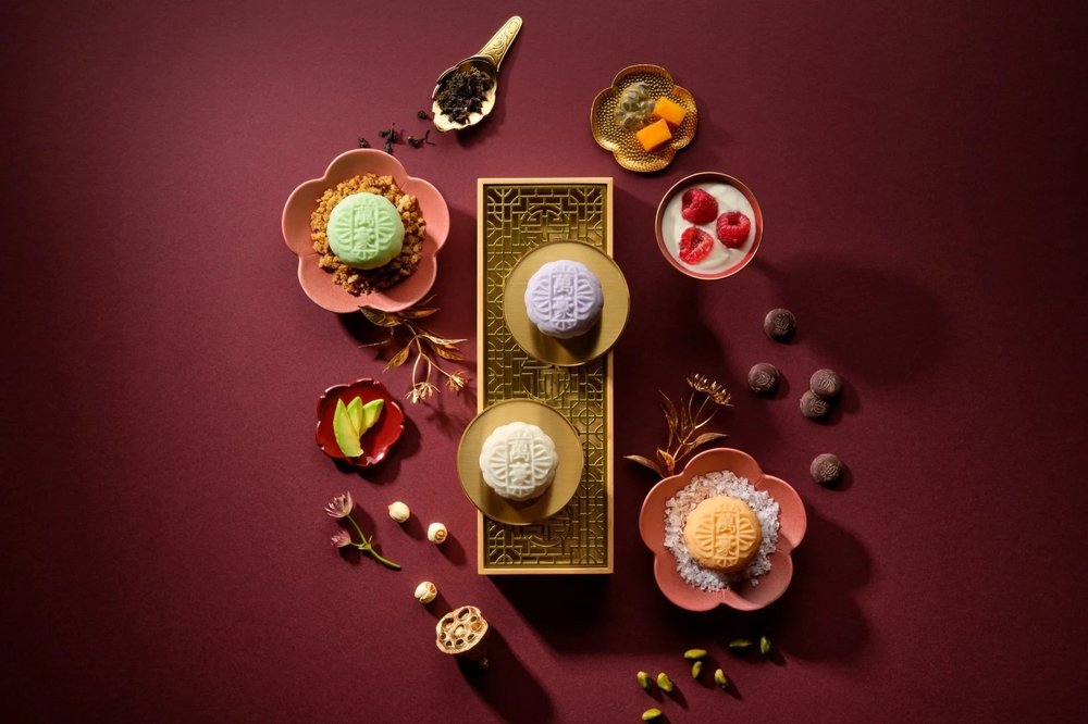 colourful snowskin mooncakes flatlay with floral plates