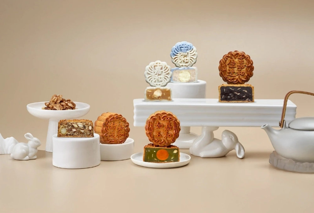 mooncakes displayed on white porcelain with teapot
