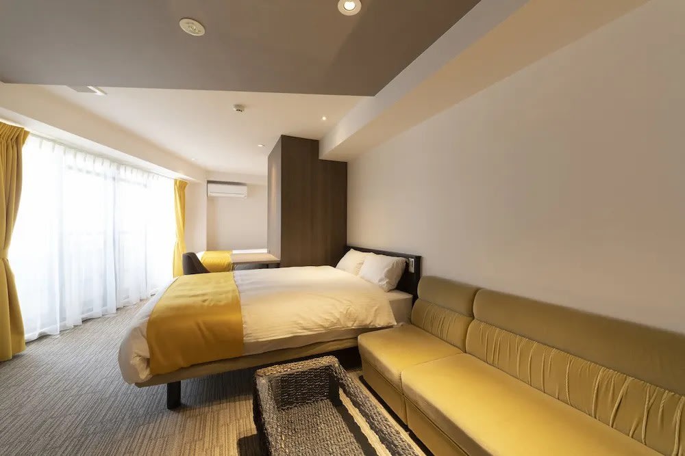 Modern guest room with double bed and sofa at Terrace Kiyomizu Kyoto