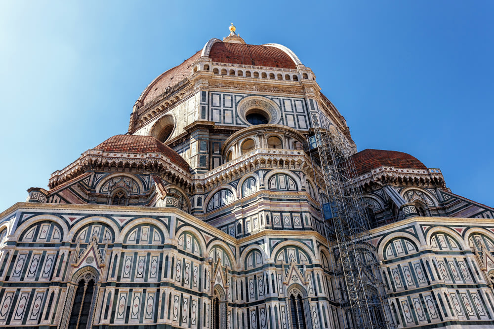 Florence Duomo dome and marble façade viewed from below