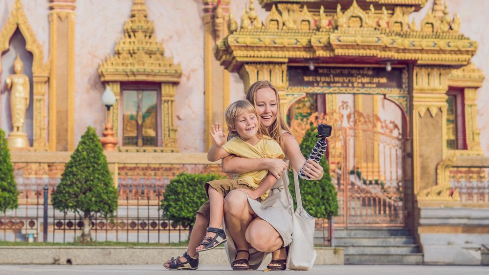 mom and son taking a photo in wat chalong temple
