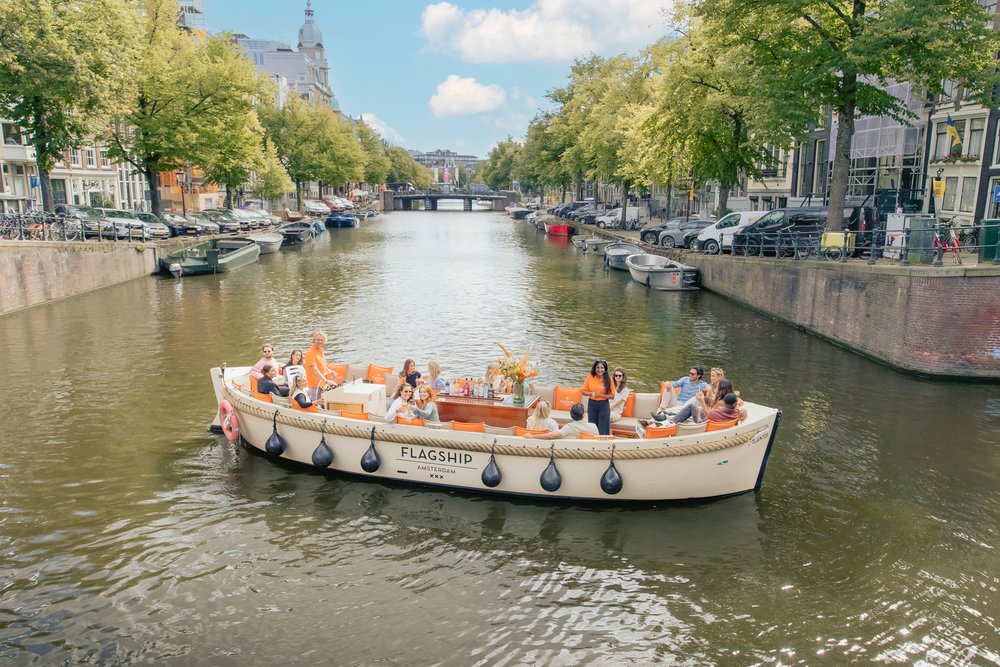 Tourists enjoy a luxury open boat canal tour in Amsterdam