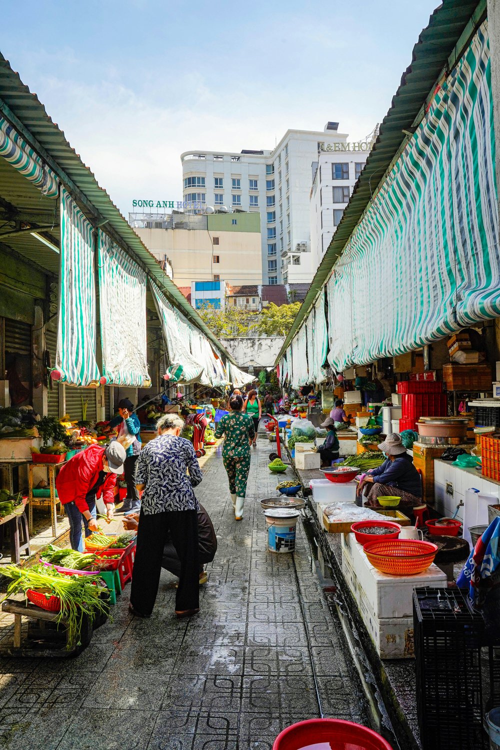 Locals shopping for fresh produce in the wet market area of Ben Thanh