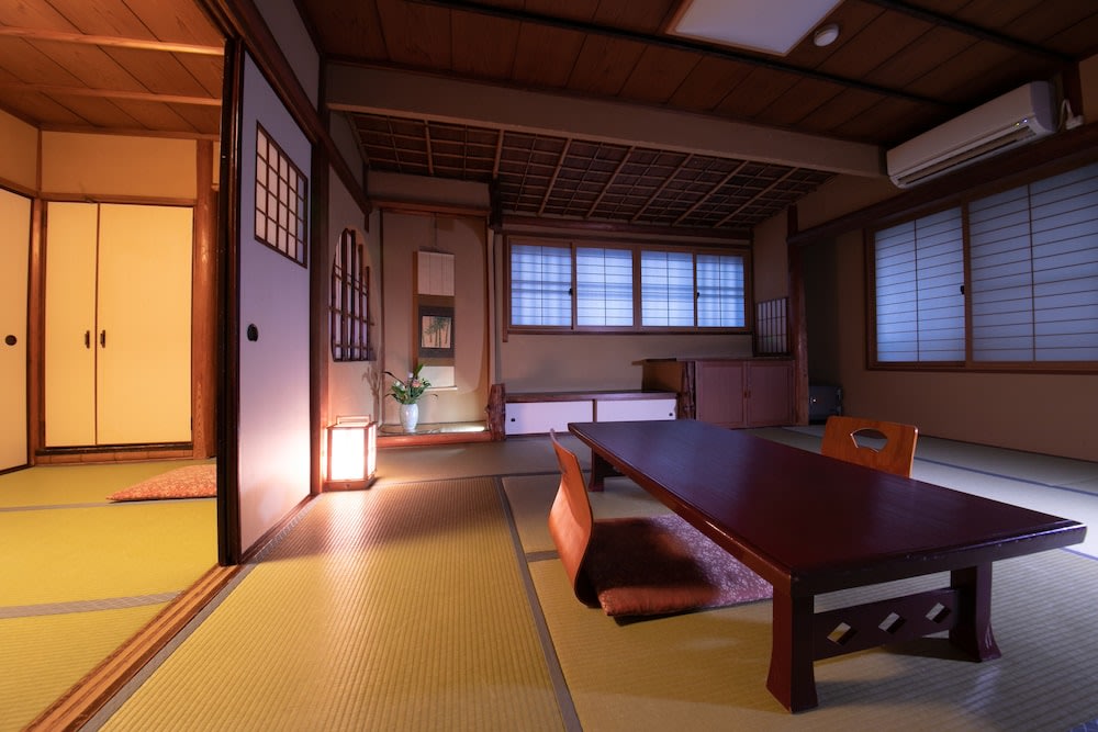A traditional ryokan room with tatami mats and shoji doors