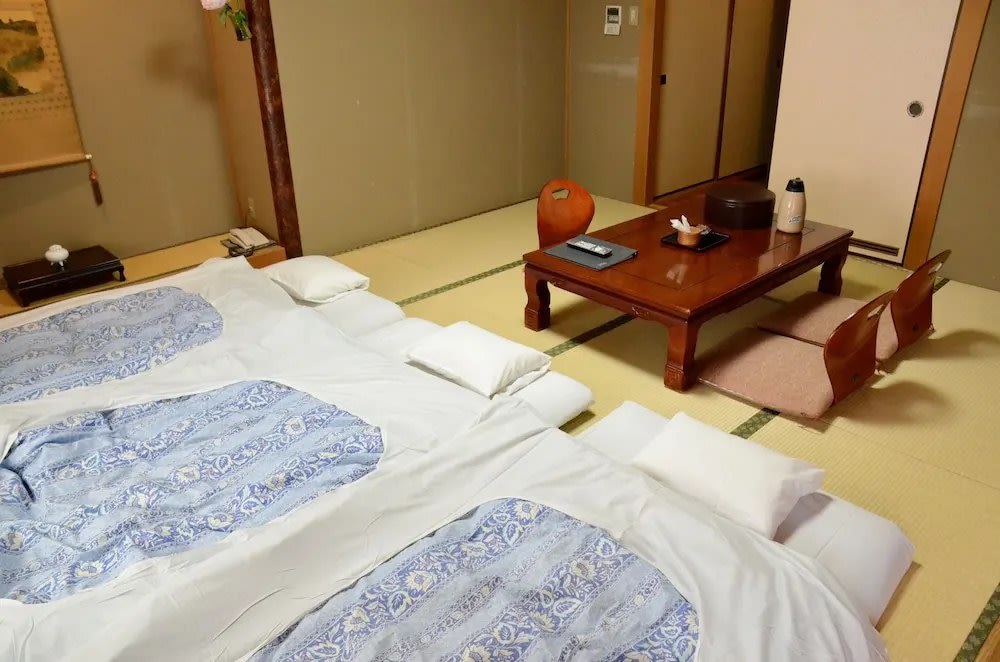 Japanese room at Ryokan Kyonoyado Kagihei with futons set up