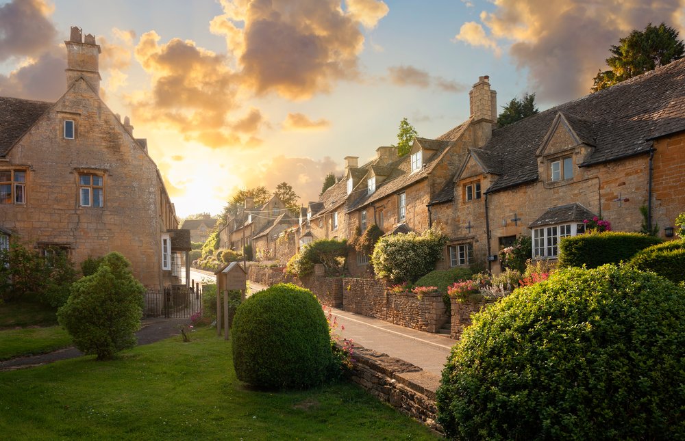 Golden stone cottages in the Cotswolds at sunset