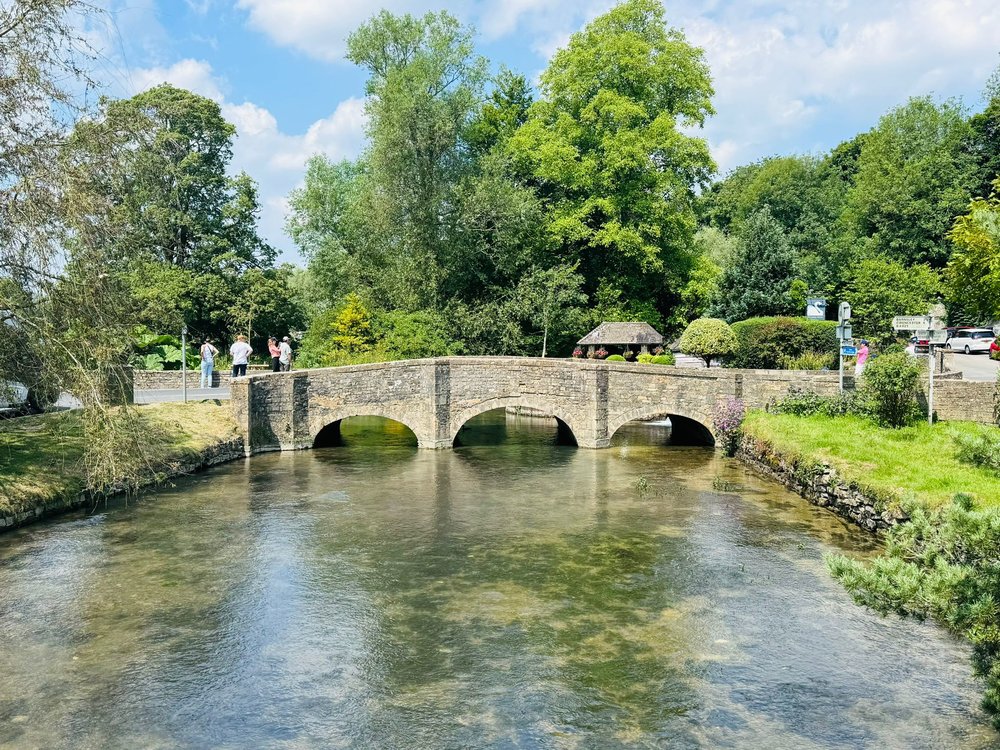 A stone bridge over a river in the Cotswolds