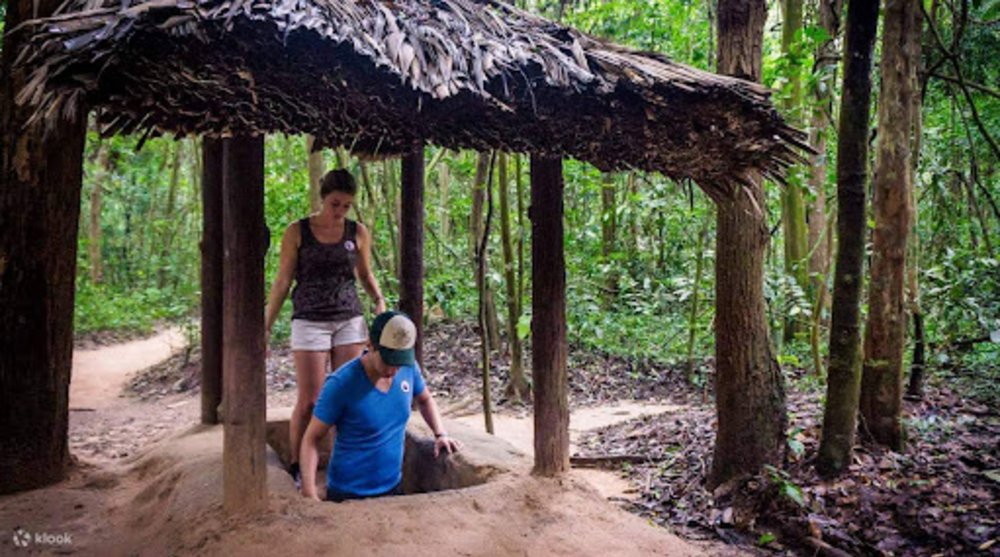 girl going inside the cu chi tunnel