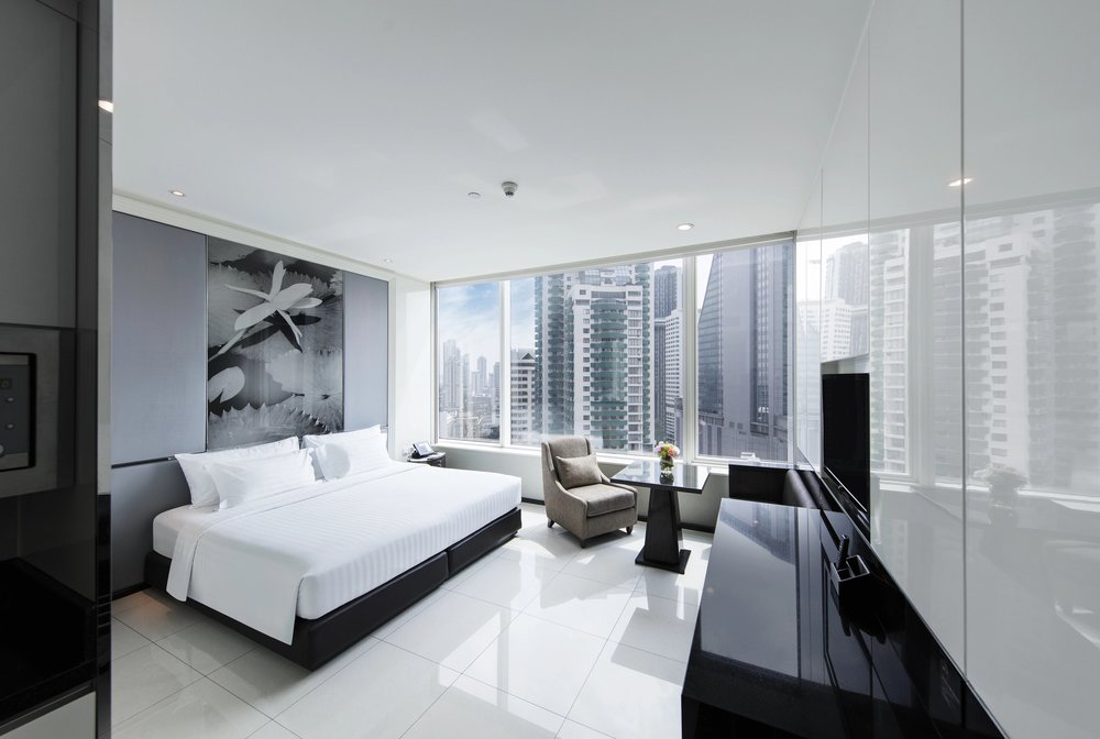 Modern hotel room with panoramic windows at Grande Centre Point Terminal 21 Bangkok