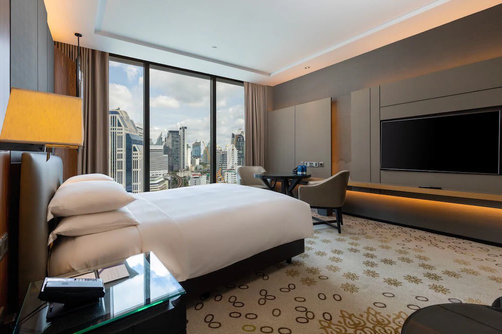 Modern hotel room with panoramic windows at Grande Centre Point Terminal 21 Bangkok