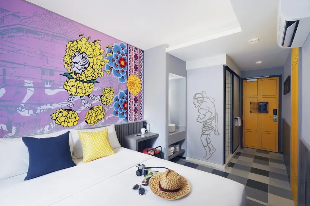 Colorful boutique-style room at Lyf Sukhumvit 8 Bangkok with wall art