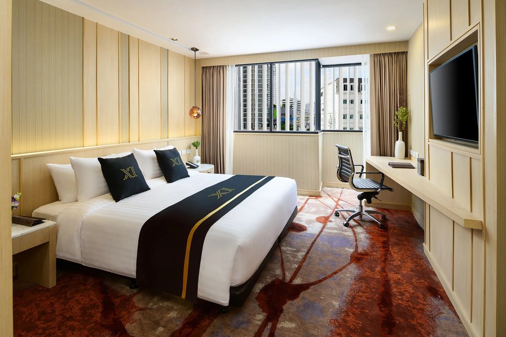 Comfortable king bedroom with work desk at Eleven Hotel Sukhumvit 11, Bangkok
