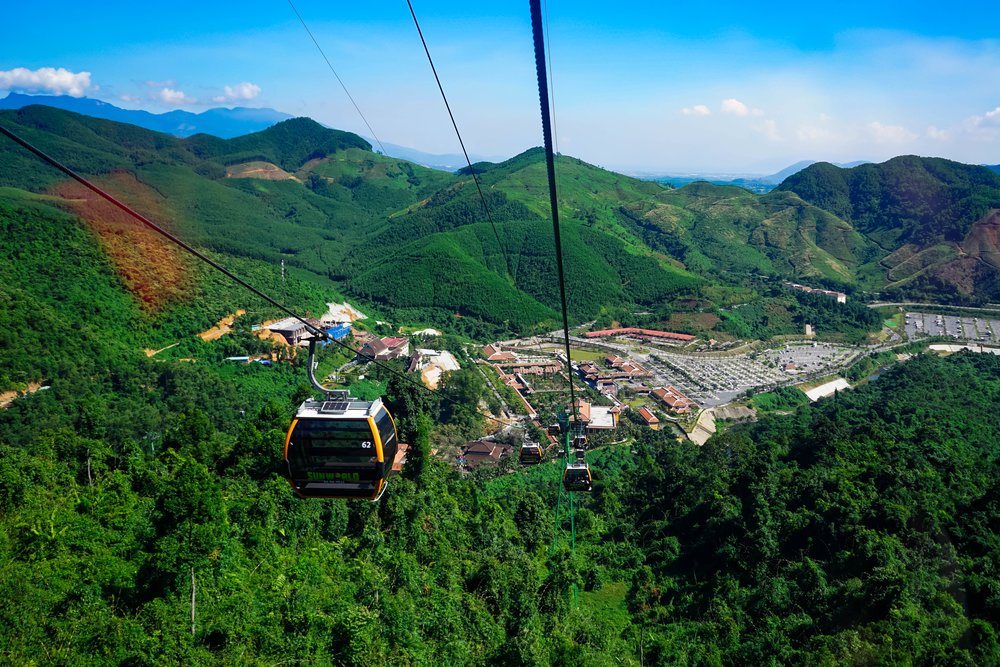Cable cars ascending over green mountains on the way to Ba Na Hills in Da Nang Vietnam