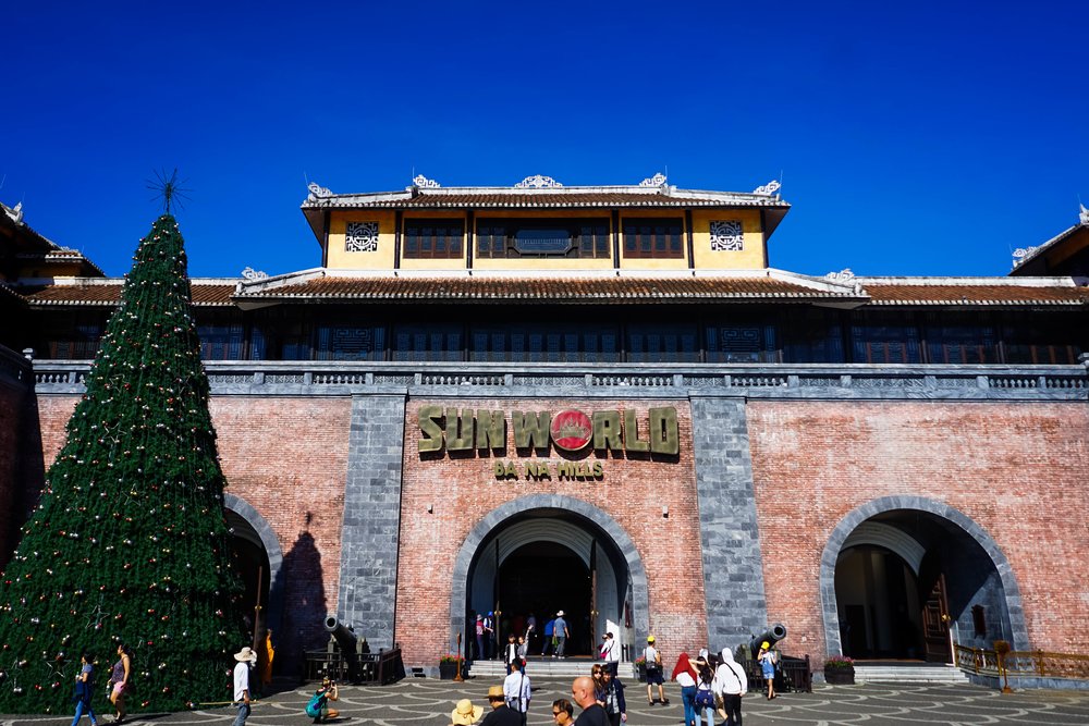 Main entrance of Sun World Ba Na Hills with visitors and a large Christmas tree