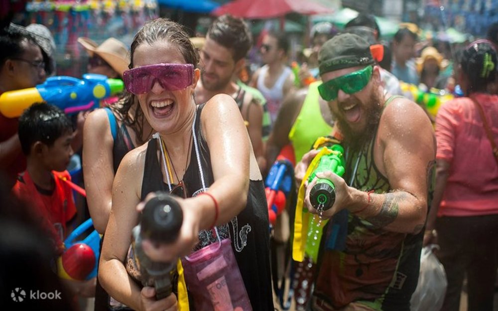 Songkran Festival attendees playing with their water guns