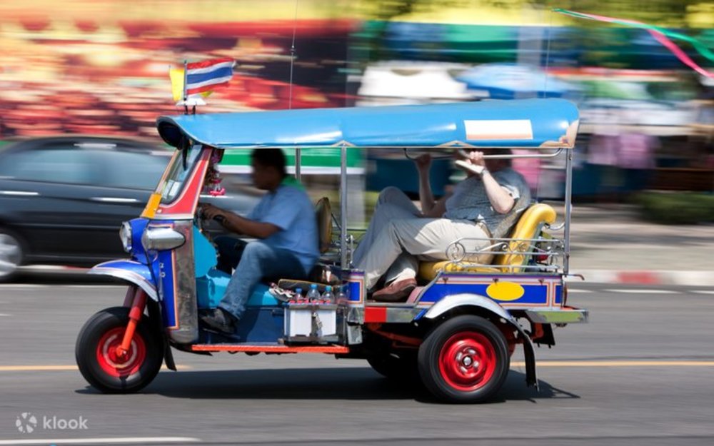 The tuk-tuk riding in motion