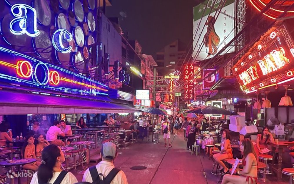 People walking down a strip of bars 