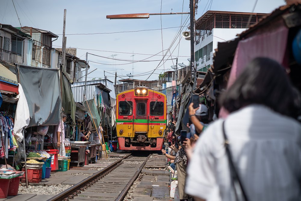 An incoming train at the Maeklong Railway Market