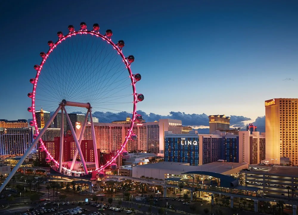 The LINQ Hotel and High Roller observation wheel glowing in pink on the Las Vegas Strip