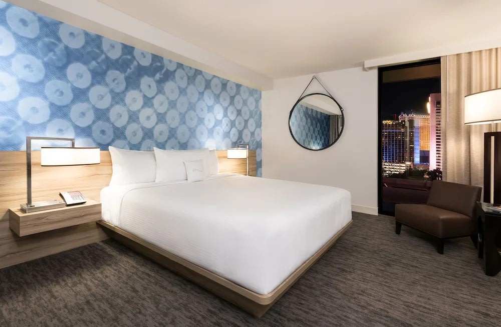 Sleek guest room at The LINQ Las Vegas featuring city views and stylish decor
