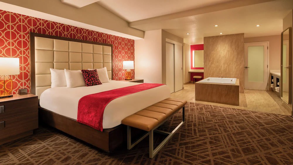 Guest room at The STRAT Hotel Las Vegas with large window and city view