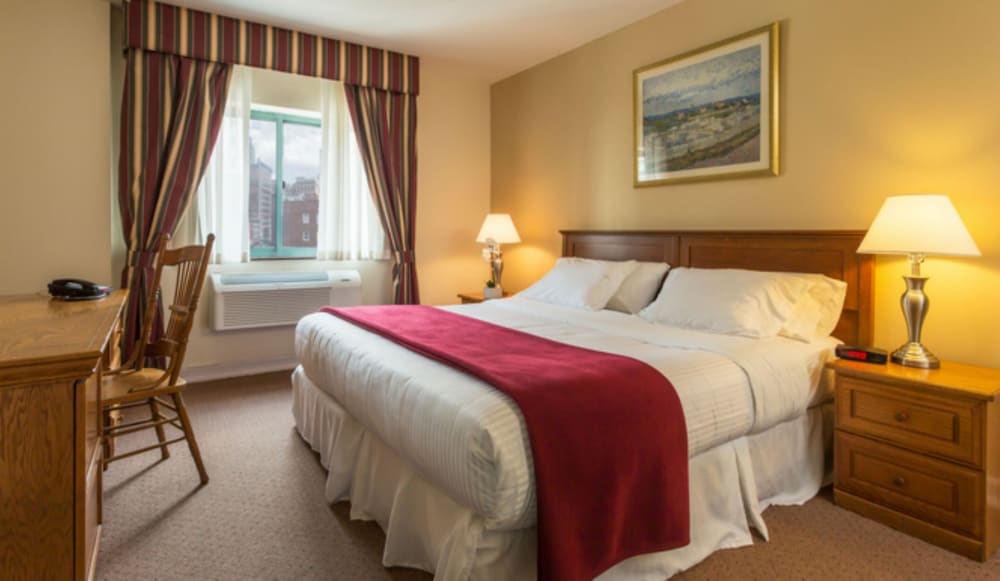 A spacious hotel bed at the Chelsea Savoy Hotel, perfect for a cozy stay