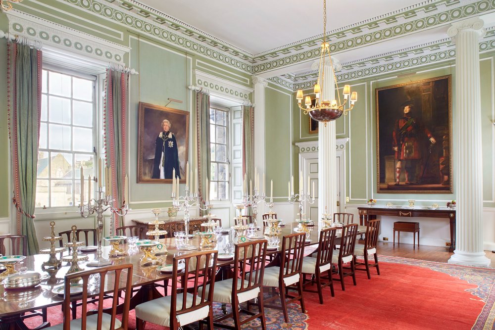 Grand dining room at Holyrood Palace with portraits and chandelier