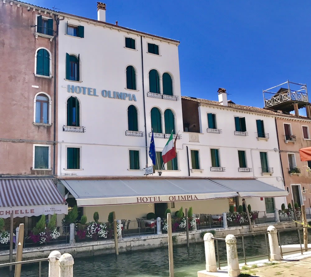The facade of Hotel Olimpia overlooking one of Venice’s many canals