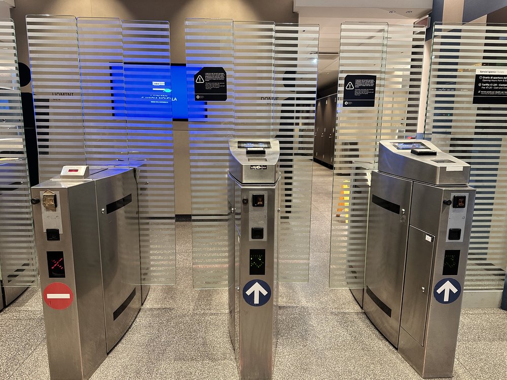 Electric gates outside Florence train station public pay bathroom