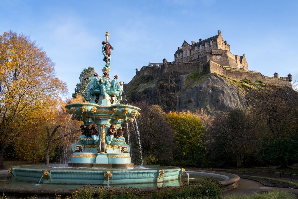 Ross Fountain with autumn trees and Edinburgh Castle on the hill behind