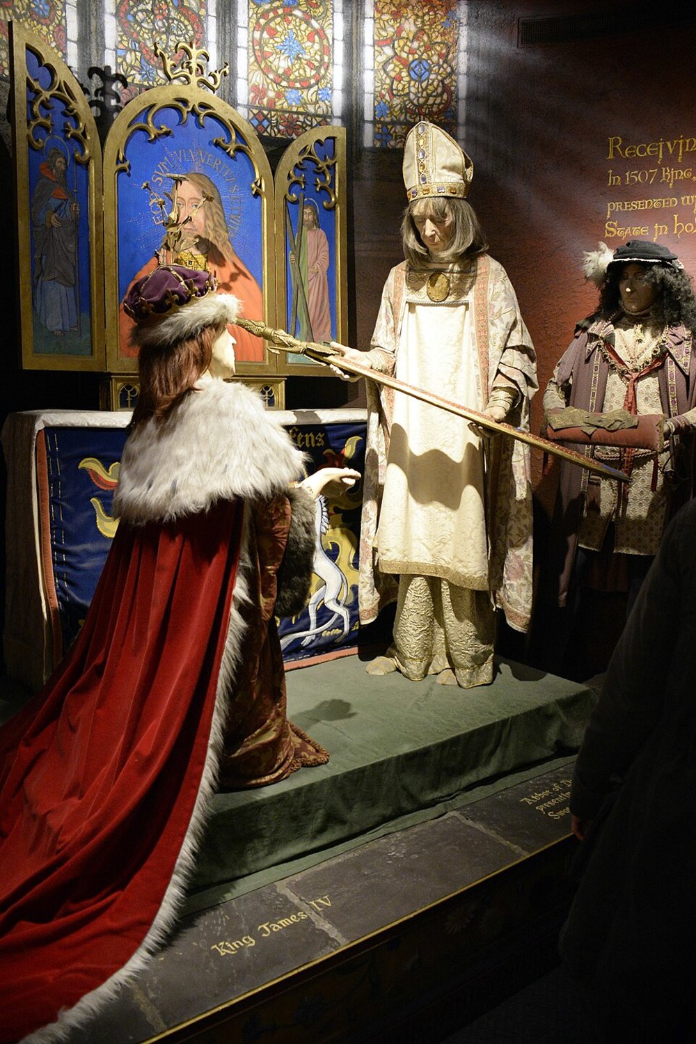 Wax figures reenacting the coronation of King James IV in Scottish royal regalia