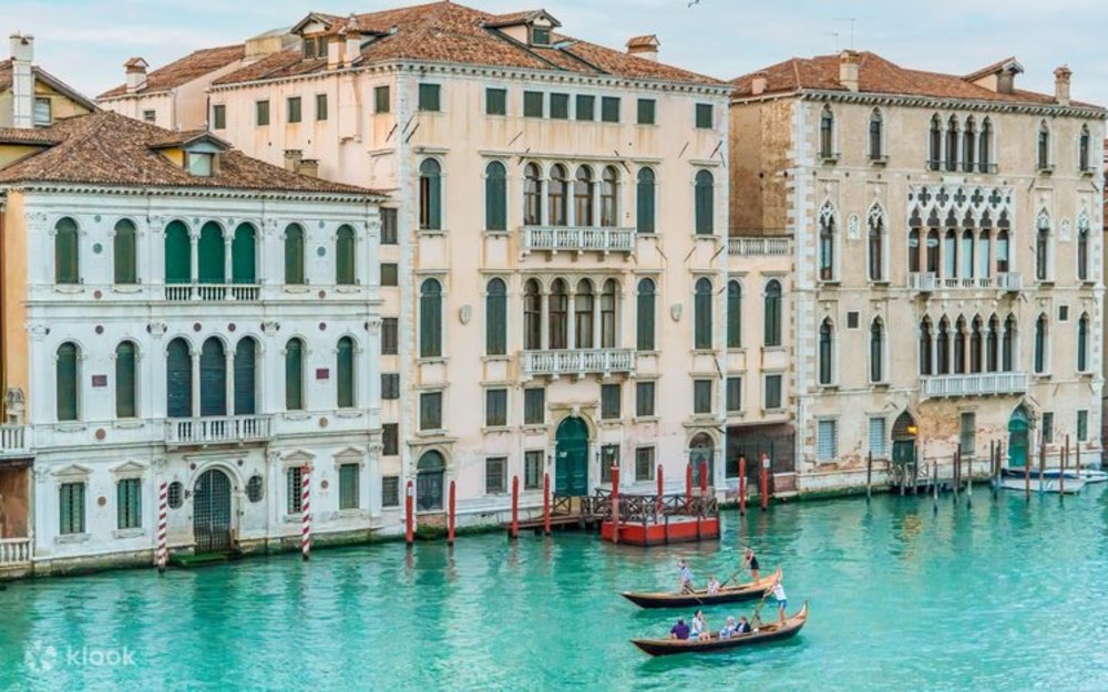 Two gondolas floating through a canal in Venice