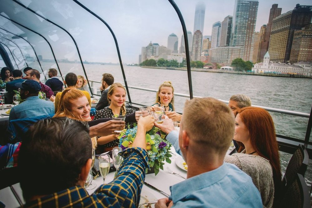 A group of friends making a toast on a cruise