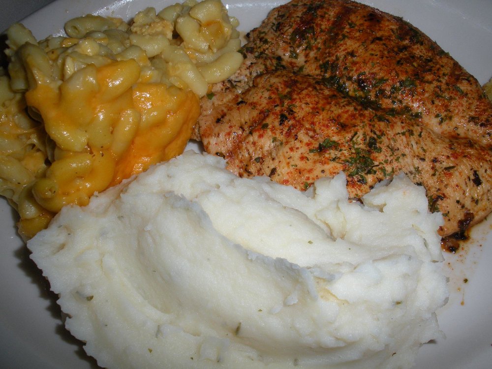 Chicken, mashed potatoes, and mac and cheese on a plate